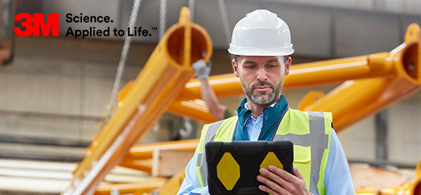 3M promotional image of an industrial worker in safety gear using a tablet in a manufacturing environment.
